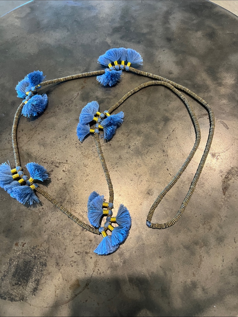Necklace.   Made of brass and tassles.  Approx 35” long can be doubled